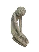 A modern stone sculpture of a kneeling figure, 47cm high
