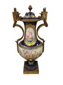 A late 19th century Sevres style ormolu mounted cobalt blue ground vase and cover, painted a