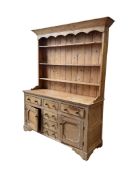An early 19th century pine dresser with boarded rack, width 155cm, depth 52cm, height 207cm