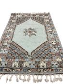 A Morrocan green ground rug