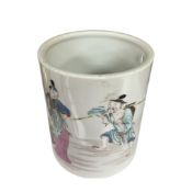 A Chinese cylindrical famille rose porcelain brush pot enamelled with figures, 12cm high