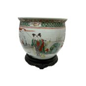 A large Chinese famille verte boys jardiniere, late 19th century, with associated hongmu stand, 38cm