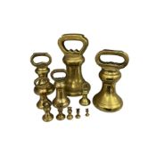 A graduated set of eleven brass bell weights, 14lbs - 1/2oz, largest 21cm high