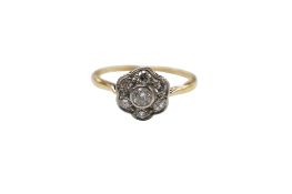 A yellow metal and seven stone diamond set cluster ring, size R, gross weight 2.6 grams.