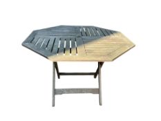 A weathered teak octagonal garden table, width 106cm, height 72cm and three folding chairs