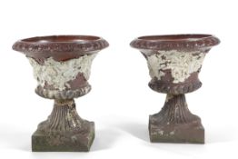 A pair of Victorian salt glazed stoneware Campana shaped garden urns, the vineous moulded bodies