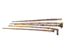 Welsh Folk Art - a group of five carved wood walking sticks, circa 1920-30s, comprising two with