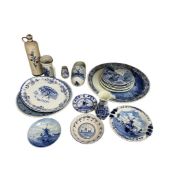 Eighteen pieces of Delft blue and white pottery to include two chargers, carafe and decorative