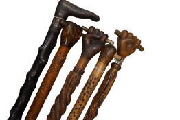 Welsh Folk Art - a group of five carved wood walking sticks, circa 1920-30s, comprising one with