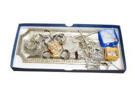 Eleven assorted silver or white metal rings, together with a continental white metal pin tray and