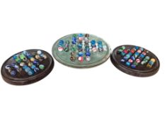 1930's hand-made marbles, on three Solitaire boards, two bakelite, one glazed stoneware, latter