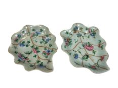 A pair of Chinese celadon leaf design dishes, enamelled with flowers, 26cm wide