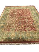 A Persian style green ground floral carpet, 365 x 285cm