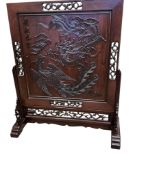 A decorative Chinese wooden panel on stand, width 104cm, depth 43cm, height 121cm