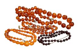 A single row graduated amber bead necklace, 43cm, gross weight 18 grams and three other necklaces.
