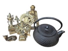 A Japanese cast iron teapot, a Chinese cast brass seated Buddha, two Thai figural castings and a