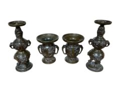 A pair of Japanese bronze candlesticks, height 21cm and a pair of similar smaller vases.