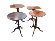 Four 19th century mahogany and oak tripod wine tables, largest diameter 55cm, height 73cm