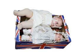 Two dolls, three minature dolls, a Vulcan child's sewing machine and a child's tea set.