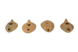 Four 2/3rd century Roman pottery oil lamps, lengths approx. 9cm.