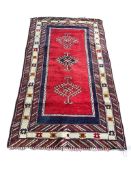 A Caucasian red ground rug, 182 x 102cm