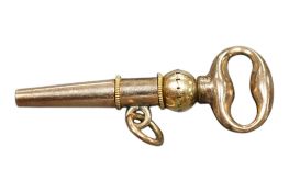 A yellow metal watch key, 27mm.