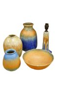 Five pieces of Ruskin pottery comprising three vases, bowl and a lamp base, largest 26cm high