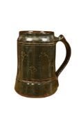 A Michael Cardew Abuja pottery mug, impressed marks to the footrim, 14cm high