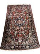 A Serbian red ground rug, 165 x 98cm