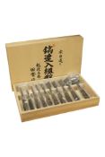 An unused Japanese wood cased chisel set, comprising of ten graduated chisels, the metal with