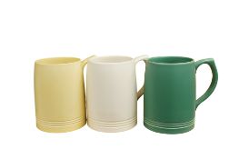Keith Murray for Wedgwood, three tankards in green white and straw glazes, height 12cm