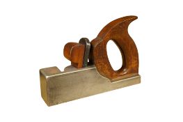 A typesetting or lead trimming plane of heavy steel construction with a notably thick be up iron and