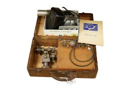 A cased early 20th century watchmaker's lathe with some accessories, the lathe 20cm long