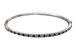 A sapphire and diamond bangle, the hinged bangle set to the front with an alternating sequence of