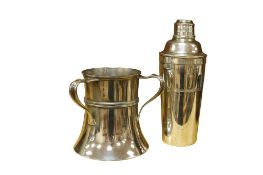 An early 20th century silver plated cocktail shaker and an Art Nouveau plated tyg, larger 25cm