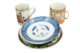 Japanese and Chinese porcelain comprising an 18th century Chinese Imari mug, a famille rose tankard,