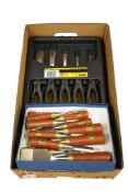 Three sets of graduated bevel edge chisels; a wood cased Stanley Bailey five chisel set, a plastic
