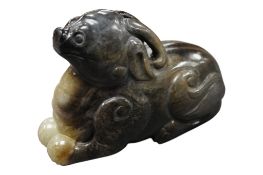 A Chinese celadon and black jade mythical beast, length 9cm.