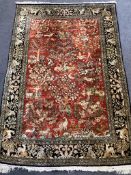 A Qum red ground part silk pictorial rug 160 x 109cm