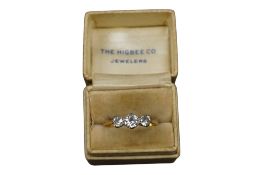 A three-stone diamond ring, claw-set with three circular-cut diamonds totalling approximately 0.60