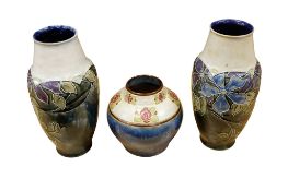 A pair of Doulton Lambeth Bessie Newbery tube lined vases, height 23cm and another smaller Doulton