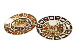 A collection of six pieces of Crown Derby Imari porcelain comprising two plates, a pin dish and a