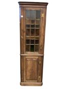 A 19th century pine standing corner cabinet, width 63cm, depth 35cm, height 197cm