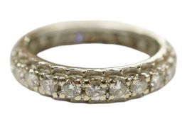A white metal and diamond set full eternity ring, size M/N, gross weight 3.8 grams.