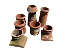 Seven terracotta chimney pots, largest height 60cm