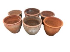 Six terracotta pots, largest diameter 46cm, height 37cm