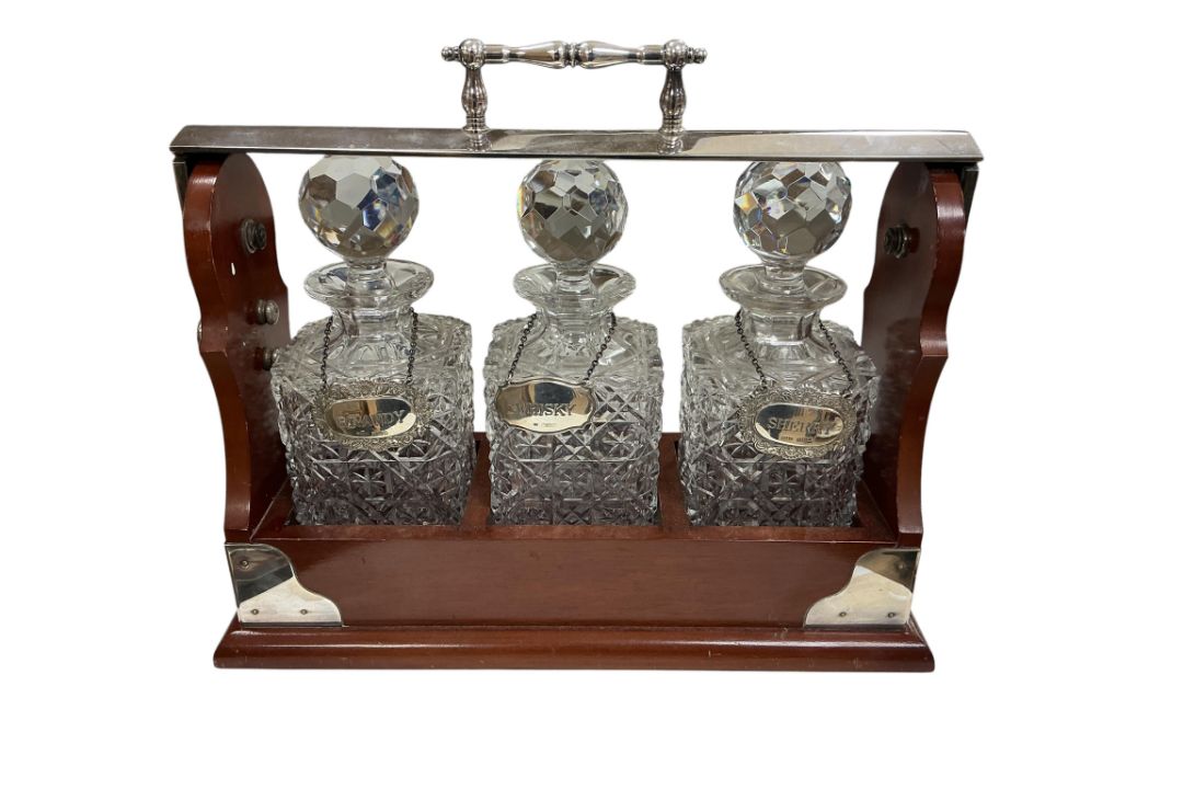 A mahogany and silver-plated tantalus, with three cut glass square decanters and stoppers, - Image 1 of 3