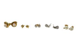 A pair of 18ct gold and cultured pearl earrings studs, a similar pair of 14k ear studs and three
