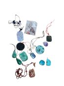 A group of Chinese carved jadeite and hardstone pendants to include a turquoise example and an