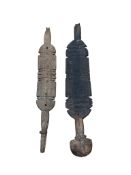 Two carved wood Tuareg tent pegs, with geometric carved decoration, longest 75cm